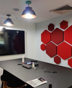 Simple hexagon office design acoustic panels in conference room shades of red